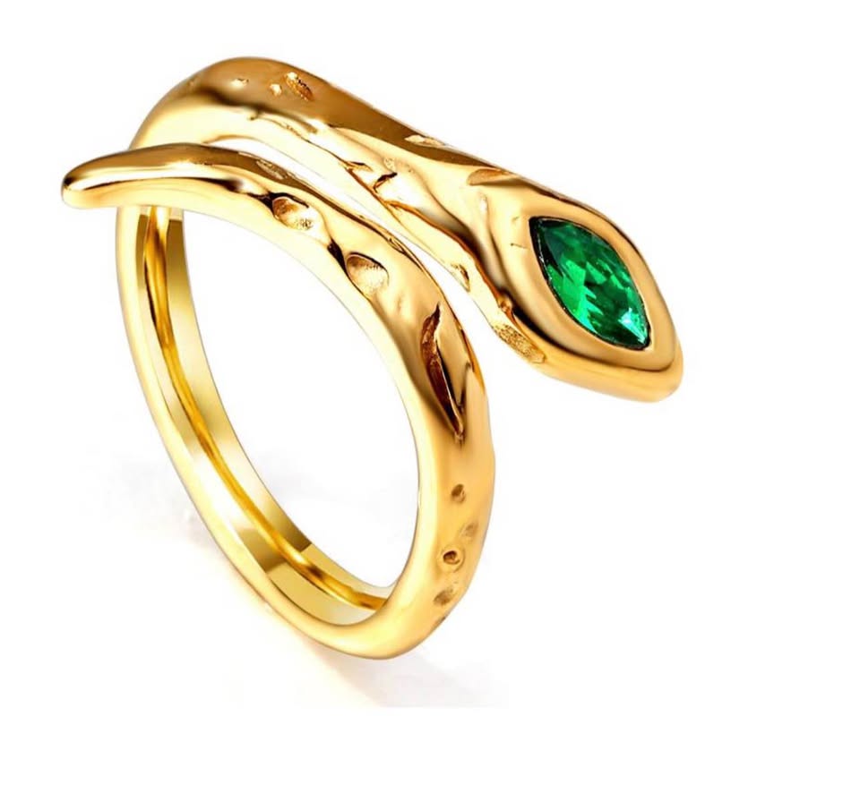 Close-up of a gold snake ring wrapping around the finger, featuring a hammered texture and a marquise-cut green stone on the head